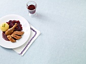 Roasted duck with red cabbage on plate 