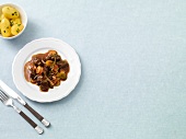 Venison goulash with colourful carrots on plate