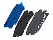 Blue, black and gray shades of eye shadow on white background