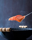 Salmon fillet on spatula over gill