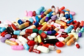 Close-up of colourful tablets and capsules on white background