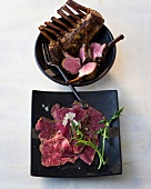 Smoked lamb chops and beef carpaccio in serving dish