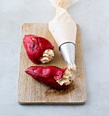 Rep peppers filled with cream cheese on chopping board