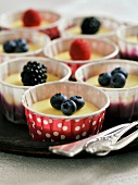 Fruit tarts with fresh berries in paper cups