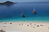 People and two ships at Kaputas beach in Turkey