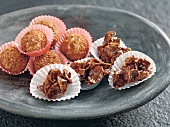 Close-up of coconut chocolates and cornflakes with almonds in cupcake cases