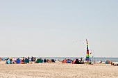 People relaxing in pop up beach tent at Fano beach, Denmark 