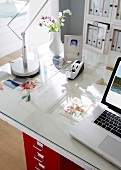 Office desk with table lamp, picture frame, laptop and door by side