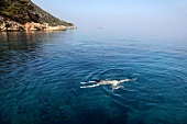 View of landscape with person swimming in Resadiye Peninsula, Turkey