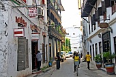 People walking in alley near Chinese restaurant in Zanzibar, Tanzania, East Africa