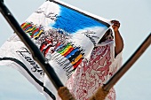 Local holding Zanzibar print cloth in Zanzibar Island, Tanzania, East Africa