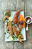 Halved quails, sweet potatoes and cocoa and chilli butter