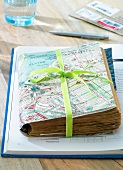 Travel diary with collected memories on table