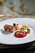 Octopus with red pepper, mint and puree on plate