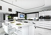 View of kitchen in white with rounded walls and fancy furniture