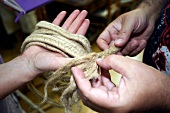 Close-up of hand Braiding stoh, Barcelona, Spain