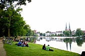 People sitting beside pond, Lubeck, Schleswig Holstein, Germany