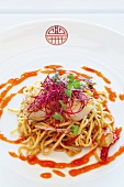 Fried noodles with scallops, sprouts and chilli jam on plate