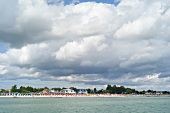 View of clouds and beach chairs on Gromitz beach in Schleswig Holstein, Germany