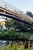 People walking on Luis bridge over the Dreisamstadion, Freiburg, Germany, backlit