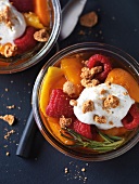 Close-up of apricots with raspberries, mascarpone, amaretti crumbs and rosemary in bowl