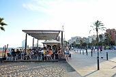 People sitting at Princesa 23 beach bar at Barcelona, Spain