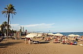 People relaxing at Platja de la Barceloneta beach in Barcelona, Spain
