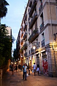 People walking in allay at calle del notariado in evening, Barcelona, Spain