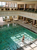 View of women in swimsuit and swimming pool in Wald & Schlosshotel Friedrichsruhe, Germany