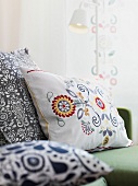 Cushions with embroidered flower motifs
