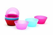 Empty colourful baking molds for muffins on white background