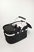 Black foldable picnic basket with cooling function on white background