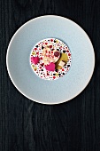 Heart shaped white chocolate with herring caviar on plate