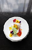 Meringue, violet ice cream with coconut and pandan sorbet on plate