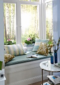 Close-up of window seating with various pillows
