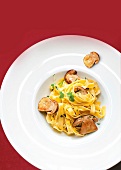Close-up of fettuccine pasta with mushrooms on plate