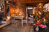 A decorated Christmas tree and a dining table in a rustic room