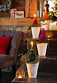 Father Christmas candles in flower pots on a flight of stairs