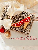 Close-up of shoe shaped biscuit on gift with white ribbon