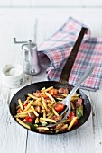 Fried tomatoes and courgettes with pasta