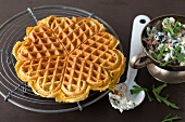 Pumpkin waffles on grill with rucola dip in cup