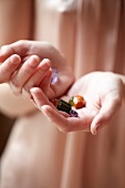 Close-up of different colour gems in hands