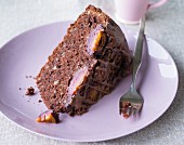 A slice of chocolate cake with plums