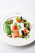 Close-up of salmon trout with ground elder, caviar, mussels and carrots on plate
