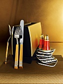 Golden utensils with toaster, salt and pepper shakers