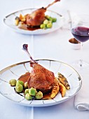 Goose confit with a trio of potato orzo pasta and Brussels sprouts