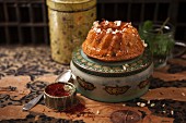 A mini Oriental Bundt cake with cashew nuts and a tin of saffron threads