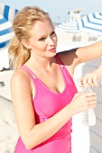 Blonde, sporty woman with a ponytail on the beach