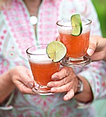 Two people toasting with Berry Spritz cocktails