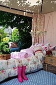 A comfortably furnished tent with colourful cushions and picnic baskets